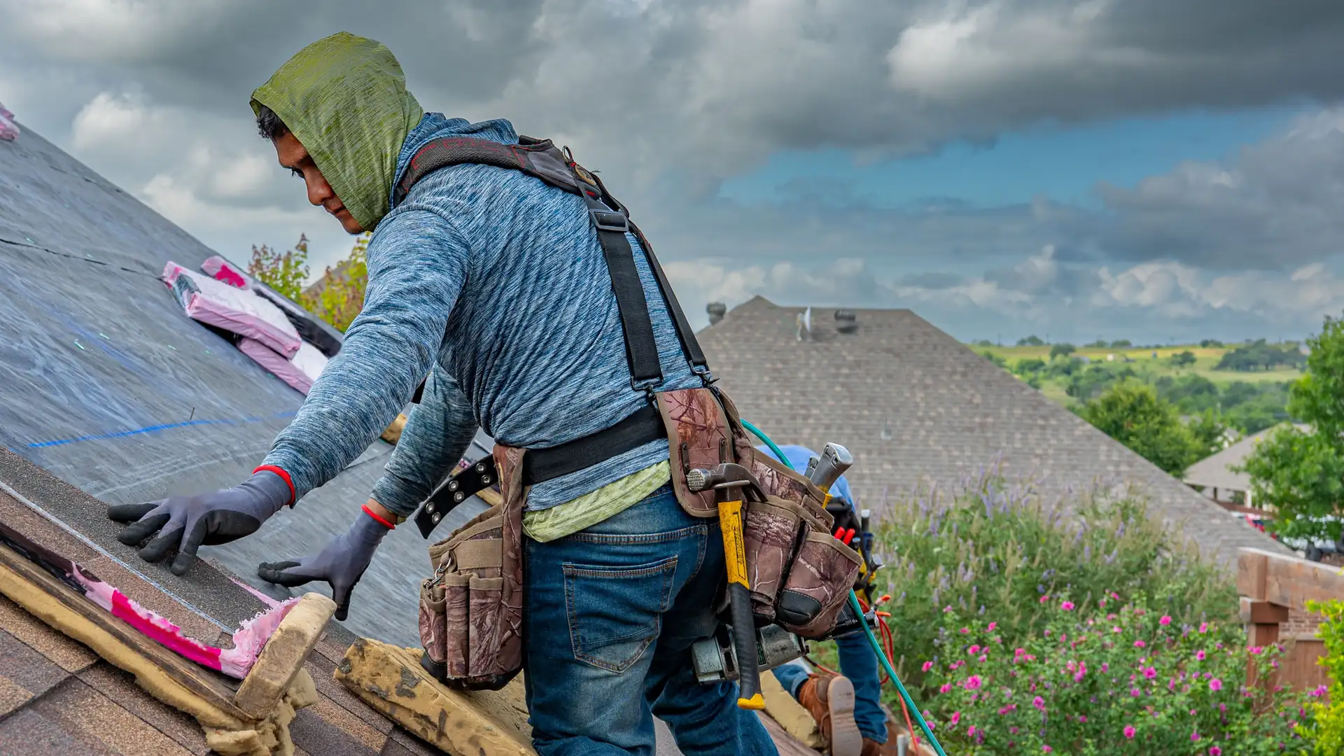 Roofing contractor working on a residential roof